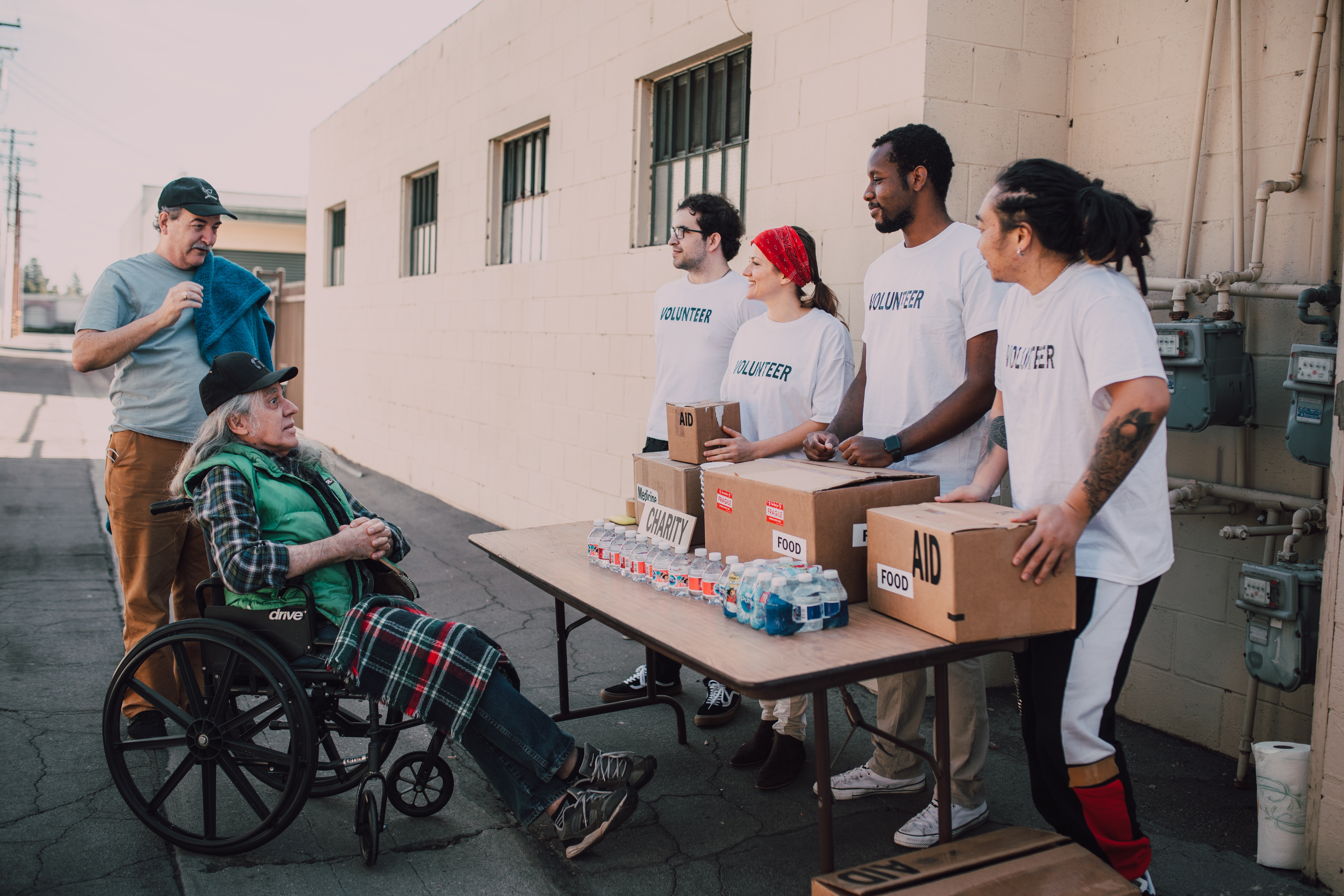 Photo by RDNE Stock project: https://www.pexels.com/photo/volunteers-assisting-an-old-man-on-a-wheelchair-6646914/